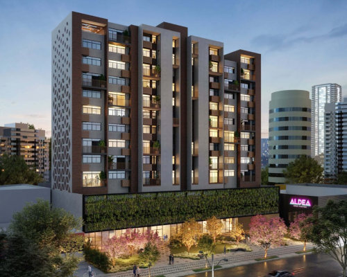 Fachada iluminada do Aldea Bias Fortes, empreendimento da Sudoeste em Lourdes, BH.