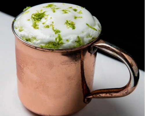 Moscow Mule em caneca de cobre, com espuma de gengibre e raspas de limão.